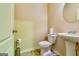 Powder room featuring a pedestal sink, toilet, and tiled floors with neutral wall color at 2325 Thackery Rd, Snellville, GA 30078