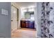 Bathroom featuring wood-tone vanity with double sinks, stylish mirror, and modern lighting fixtures at 2325 Thackery Rd, Snellville, GA 30078