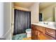 Bathroom featuring a wooden vanity, toilet, shower with a curtain, and tiled floor at 2325 Thackery Rd, Snellville, GA 30078