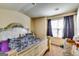 Bedroom showcasing a decorative headboard, window with curtains, and carpeted floor at 2325 Thackery Rd, Snellville, GA 30078