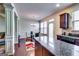 Open layout showing granite kitchen and dining area with hardwood floors and lots of light at 2325 Thackery Rd, Snellville, GA 30078