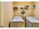 Laundry room with a washer, dryer, and wire shelving above for organized storage solutions at 2325 Thackery Rd, Snellville, GA 30078