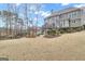 Expansive backyard view featuring a multilevel deck, firepit, and manicured lawn, creating an inviting outdoor oasis at 804 Carnellian Ln, Peachtree City, GA 30269