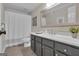 Bathroom features a shower with white curtain and grey vanity with solid surface countertops at 804 Carnellian Ln, Peachtree City, GA 30269