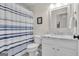 Bathroom features a shower with blue and white striped curtain and vanity with solid surface countertops at 804 Carnellian Ln, Peachtree City, GA 30269