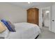 Bedroom with armoire and carpet, leading to an ensuite bathroom at 804 Carnellian Ln, Peachtree City, GA 30269