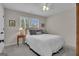 Neutral bedroom featuring a comfortable bed, wooden nightstand and a sunlit window at 804 Carnellian Ln, Peachtree City, GA 30269