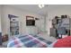 Spacious bedroom featuring a TV, bookcase, desk, and a window bringing in natural light at 804 Carnellian Ln, Peachtree City, GA 30269