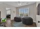 Bonus room features a blue rug, hardwood floors, 2 bean bag chairs and natural light at 804 Carnellian Ln, Peachtree City, GA 30269