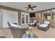 Cozy covered patio featuring wicker seating, a ceiling fan, and scenic views of the stone wall, creating a relaxing outdoor space at 804 Carnellian Ln, Peachtree City, GA 30269