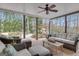 Relaxing covered patio with wicker furniture, ceiling fan, and views of the wooded backyard creating a serene outdoor retreat at 804 Carnellian Ln, Peachtree City, GA 30269