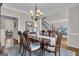 Formal dining room with wood floors, seating for six, and views through to the living room and stairway at 804 Carnellian Ln, Peachtree City, GA 30269