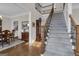 Inviting foyer with hardwood floors, staircase, and view into dining room at 804 Carnellian Ln, Peachtree City, GA 30269