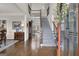 Welcoming foyer with hardwood floors, staircase, and views into adjacent rooms with hardwood floors at 804 Carnellian Ln, Peachtree City, GA 30269