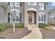 Close up of a home's entryway showing the front door with decorative wreath and nearby trimmed shrubbery at 804 Carnellian Ln, Peachtree City, GA 30269