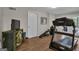 Gym features a treadmill, a weight bench, an antique cabinet, and hardwood floors at 804 Carnellian Ln, Peachtree City, GA 30269