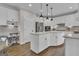 Bright kitchen features white cabinets, a large island, stainless steel appliances, and pendant lighting at 804 Carnellian Ln, Peachtree City, GA 30269