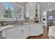 Well-lit kitchen featuring white cabinetry, a stainless steel sink, and marble countertops at 804 Carnellian Ln, Peachtree City, GA 30269