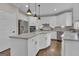 Spacious kitchen with white cabinetry, marble countertops, stainless appliances, and a gray tile backsplash at 804 Carnellian Ln, Peachtree City, GA 30269