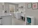 Functional laundry room featuring a sink, white cabinets, counter space, and a window for natural light at 804 Carnellian Ln, Peachtree City, GA 30269