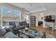 Living room with hardwood floors, a grey couch, a ceiling fan, and natural light at 804 Carnellian Ln, Peachtree City, GA 30269