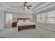 Spacious main bedroom with a tray ceiling and a ceiling fan at 804 Carnellian Ln, Peachtree City, GA 30269