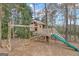 ' playground featuring a slide, swings, and climbing structure, set amidst a leafy, serene backyard environment at 804 Carnellian Ln, Peachtree City, GA 30269