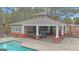 Community pool house with picnic seating, a grill, and lounge area by the pool at 804 Carnellian Ln, Peachtree City, GA 30269