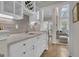 A bright wet bar with white cabinets and wine rack opens to the living room at 804 Carnellian Ln, Peachtree City, GA 30269