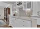 A bright wet bar with white cabinets, light gray backsplash, and a wine rack at 804 Carnellian Ln, Peachtree City, GA 30269