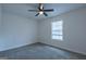 Carpeted bedroom features a ceiling fan and a window with natural light at 141 Muirwood Dr, Temple, GA 30179