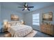 Comfortable bedroom with blue walls, natural light, and a cozy queen-size bed at 141 Muirwood Dr, Temple, GA 30179