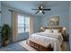 Airy bedroom with blue walls, lots of natural light, and a comfortable king-size bed at 141 Muirwood Dr, Temple, GA 30179