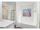 Bright bathroom showcases a luxurious bathtub, quartz countertops, and a glass-door shower for a spa-like experience at 1320 Kay Se Ter, Conyers, GA 30013