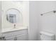 Stylish half bath with modern vanity, round mirror, and elegant fixtures at 1320 Kay Se Ter, Conyers, GA 30013