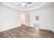 Bedroom with wood floors, bright white walls, tray ceiling, and a view to the bathroom at 1320 Kay Se Ter, Conyers, GA 30013