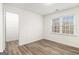 Light-filled bedroom with hardwood floors, a large window, and an adjacent closet offers ample space and storage at 1320 Kay Se Ter, Conyers, GA 30013