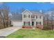 Charming two-story home featuring a manicured lawn, two-car garage, and classic brick accents at 1320 Kay Se Ter, Conyers, GA 30013