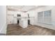 Updated kitchen features white cabinetry, a center island, stainless steel appliances, and hardwood floors at 1320 Kay Se Ter, Conyers, GA 30013