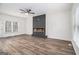 Open living area with modern fireplace, neutral walls, ceiling fan, and luxury vinyl plank flooring at 1320 Kay Se Ter, Conyers, GA 30013