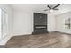 Bright living room showcasing a modern fireplace, a ceiling fan, and natural light from surrounding windows at 1320 Kay Se Ter, Conyers, GA 30013