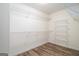 Walk-in closet features custom shelving and wood-look flooring at 1320 Kay Se Ter, Conyers, GA 30013