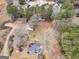 Aerial view of property showcasing house, surrounding buildings and foliage at 6393 Walker Rd, Riverdale, GA 30296