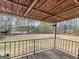 Back porch with black metal railing overlooking expansive green backyard at 6393 Walker Rd, Riverdale, GA 30296