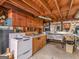 View of the basement kitchenette with exposed wood beams and stainless steel sink at 6393 Walker Rd, Riverdale, GA 30296