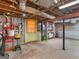 Unfinished basement showcasing door, water heater, and storage shelving at 6393 Walker Rd, Riverdale, GA 30296