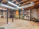 Unfinished basement with concrete floor, block foundation, exposed ducts, and yellow door at 6393 Walker Rd, Riverdale, GA 30296