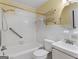 Bathroom featuring white tiled walls, tub, toilet, vanity, and neutral color scheme at 6393 Walker Rd, Riverdale, GA 30296