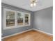 Bedroom with a ceiling fan, hardwood floor, and a large bank of windows at 6393 Walker Rd, Riverdale, GA 30296