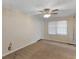 Carpeted bedroom with a ceiling fan and lots of natural light from a large window at 6393 Walker Rd, Riverdale, GA 30296